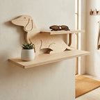 Hand made wooden shelf shaped like a dachshund with a plant and sunglasses on a neutral wall.